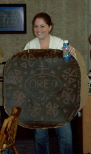 Person Holding a Bottle and Wearing an Oreo Sign
