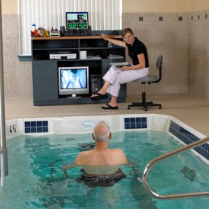 Person participating in underwater therapy with instructor