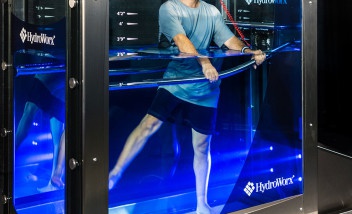 Person stretching legs underwater in HydroWorx tank