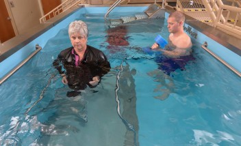 Two people training in a HydroWorx pool