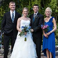 People in suits and dresses posing for photograph
