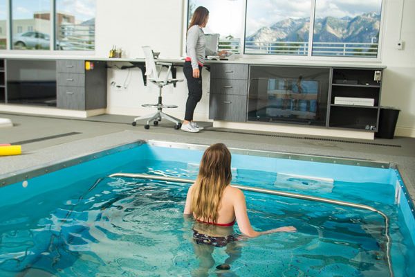 pool room with a young woman walking