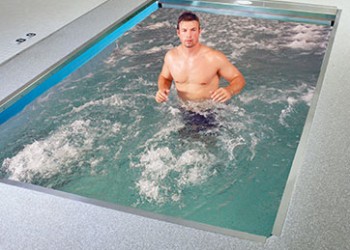 Person running against jet currents in pool