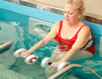 Person lifting weights in pool