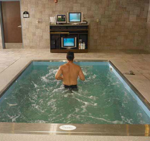 Person running against current in therapy pool