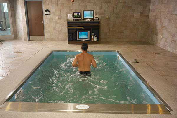 Person running against current in therapy pool