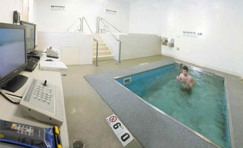 Person running against current in therapy pool