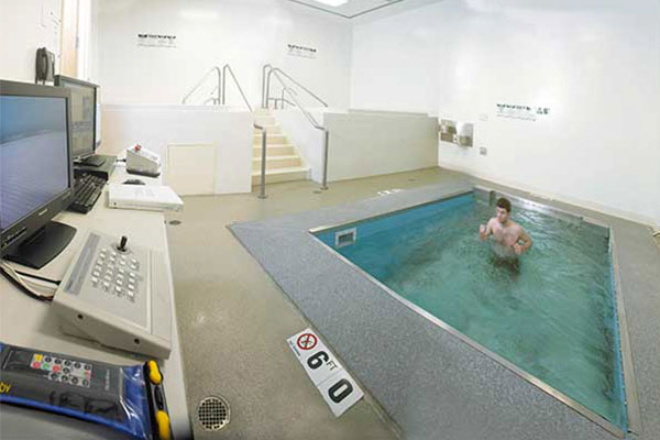 Person running against current in therapy pool