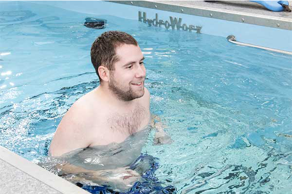Person smiling and running in HydroWorx Pool