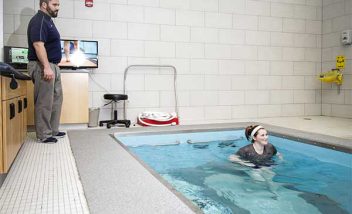 Person helping to train in HydroWorx Pool