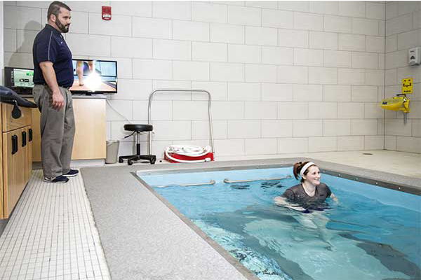 Person helping to train in HydroWorx Pool