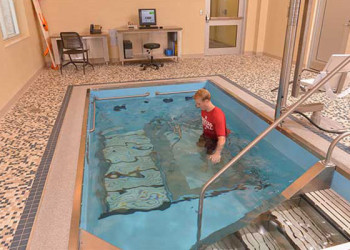 Person training on pool treadmill