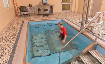 Person training on pool treadmill