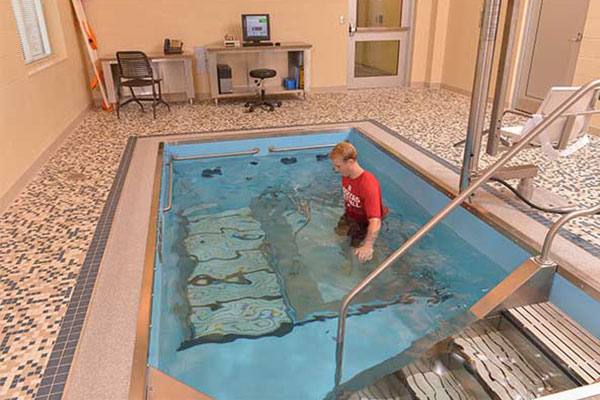 Person training on pool treadmill