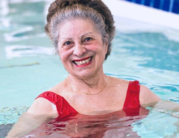 Elder smiling in HydroWorx pool