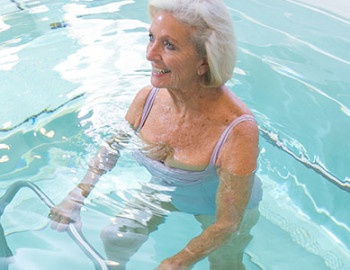 Person holding metal bars in pool