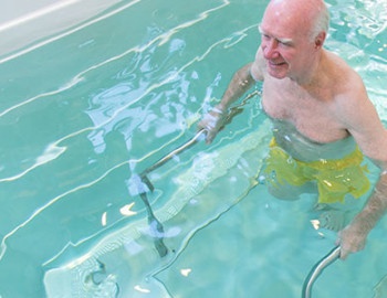 Person holding metal bars in pool