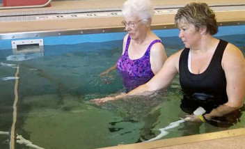 Two people using water massage hose