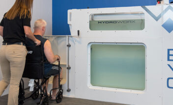 man in wheelchair using handicap entrance to evo