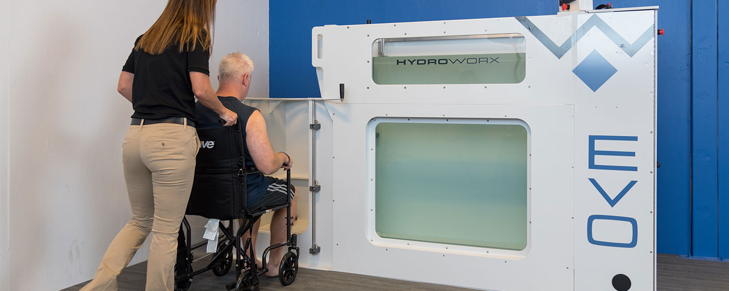 man in wheelchair using handicap entrance to evo