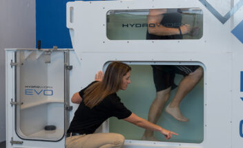 trainer working with athlete in hydroworx evo